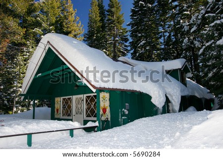 Fresh snow covering lovely wooden cabin
