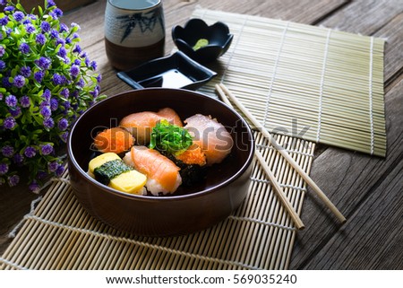 Sushi set and sushi rolls served on wood table, selective focus