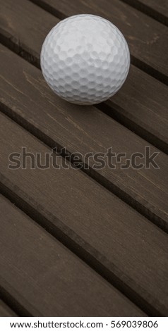Golf ball over wooden background