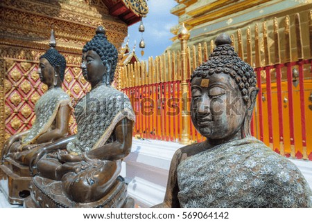Bronze Buddha statues in famous golden buddhist temple, symbol of peace and meditation,  Wat Phra That Doi Suthep, Chiang Mai, Thailand 