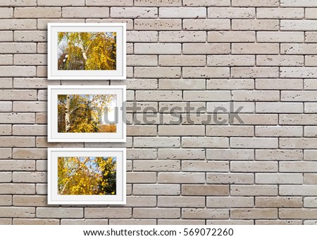 Modern frames mock ups with colorful autumn motif pictures on decorative bricks wall. Interiors decor idea.