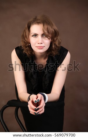 Girl posing in a studio on brown background