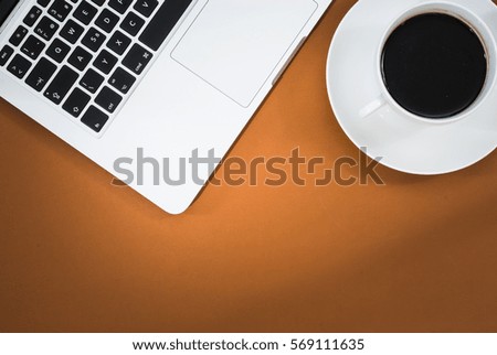 Business workspace concept. Top view. Orange workspace concept with laptop and coffee.