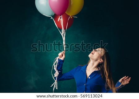 Air colored balls in the studio happy woman