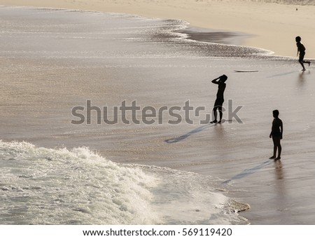 Silhouette of unidentifiable people on a beach in Rio de Janeiro, Brazil