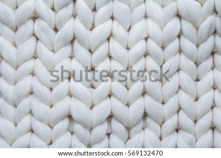 background texture of knitted things from thick woolen yarn / background knitwear Royalty-Free Stock Photo #569132470