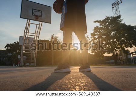 Basketball players playing basketball outdoor. Royalty-Free Stock Photo #569143387