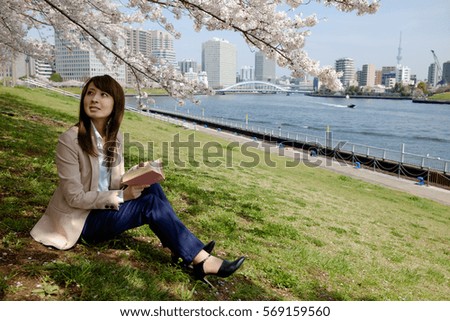 The woman who reads a book under the cherry tree