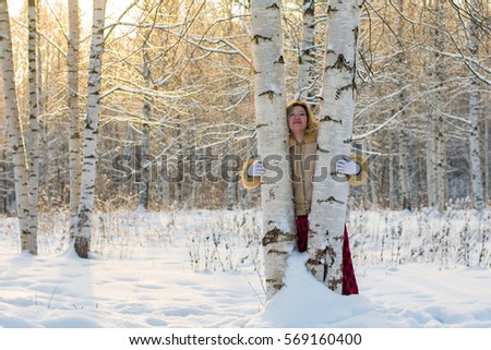 Woman in the forest in a sunny winter day