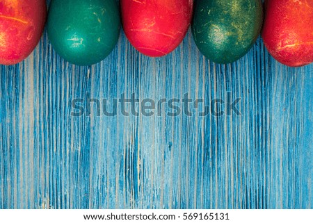 Abstraction painted Easter eggs on a blue background. Studio Photo