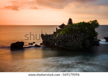 Temple of Tanah Lot in Bali at sunset Royalty-Free Stock Photo #569179096
