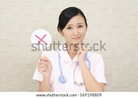 Female nurse with a No sign
