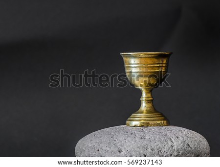 Old chalice on stone Royalty-Free Stock Photo #569237143