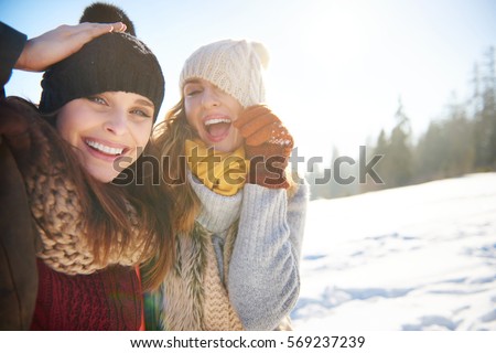 Funny friends playing with hats