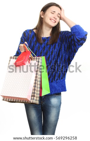 Happy girl holding shopping bags. The concept of selling, buying, fashion.