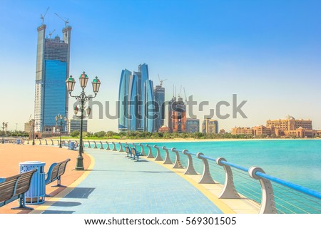 Dhabi skyline from cycle paths of Corniche. Abu Dhabi, United Arab Emirates, Middle East. Modern skyscrapers and landmark on background. Summer holidays concept. Royalty-Free Stock Photo #569301505