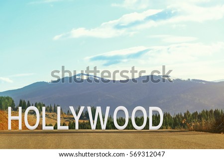 Word HOLLYWOOD on landscape background