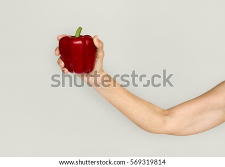 Hand Holding Red Bell Pepper