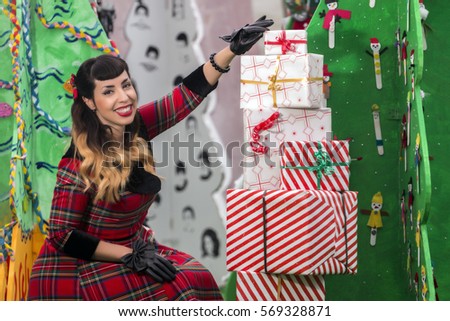 View of a colorful and cute christmas pinup girl with presents.