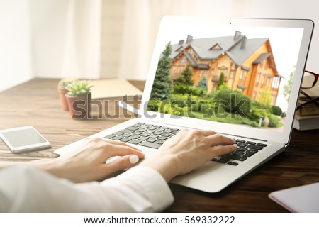 Online shopping concept. Woman looking for house on real estate market website Royalty-Free Stock Photo #569332222