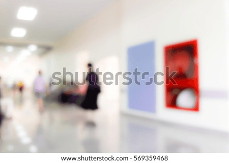 Blur image of walkway in hospital near the emergency door and fire extinguishers, use for background.