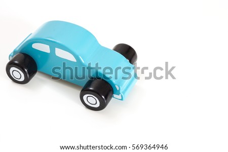 A blue toy car, on white background with copy-space.