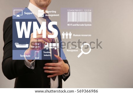 Warehouse management system concept. Man working with virtual screen Royalty-Free Stock Photo #569366986