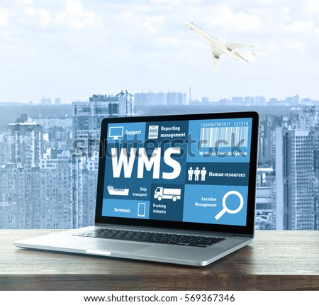 Warehouse management system concept. Laptop on table against cityscape background Royalty-Free Stock Photo #569367346