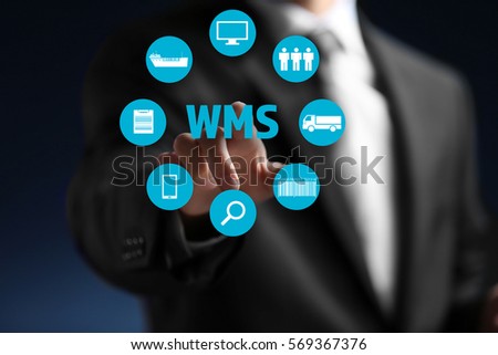 Warehouse management system concept. Man working with virtual screen Royalty-Free Stock Photo #569367376