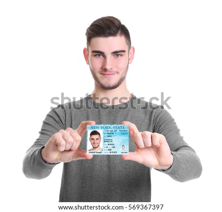Man with driving license on white background Royalty-Free Stock Photo #569367397