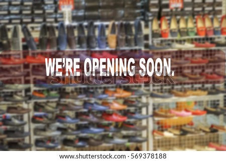 We're opening soon text on blur shopping complex background.