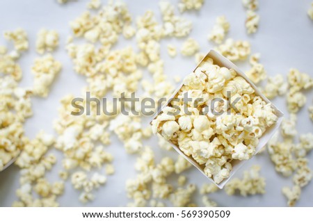 Popcorn homemade yellow cardboard box on white background