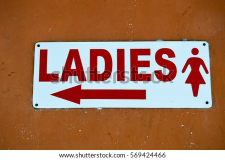 Signboard ladies with an arrow and a silhouette