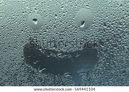 The smile on the wet glass. Background of the drops of rain. Condensate texture.