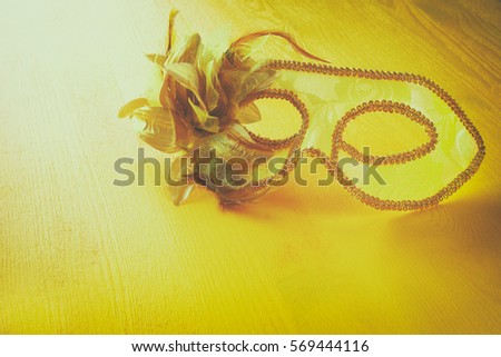 Image of yellow lace elegant venetian mask.