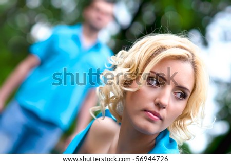 Young woman and man in park, selective focus