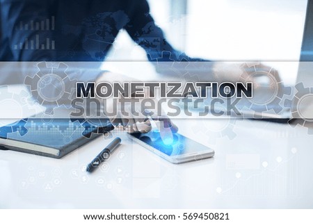 Businessman working in office, pressing button on virtual screen and selecting monetization.