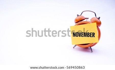 Conceptual image of Business Concept with words " November" on a clock with a white background. Selective focus.                 