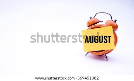 Conceptual image of Business Concept with words "August" on a clock with a white background. Selective focus.                 