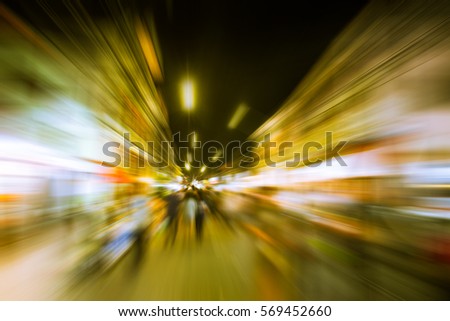 Speedy urban lifestyle, Night market street with fast speed motion blur zoom effect.