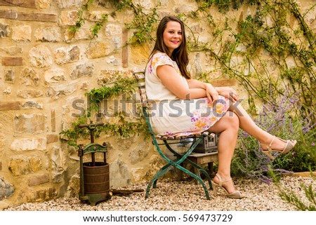 View of a female sitting on the chair during summer in beautiful Tuscany scenery
