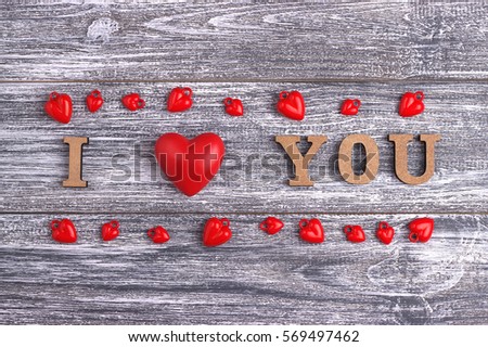 I love you, wooden with red heart lettering, gray wooden background, postcard Happy Valentine day, flat lay 