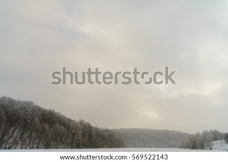 Winter landscape with fog on the lake