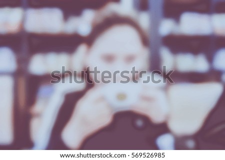 Picture blurred  for background abstract and can be illustration to article of woman drinking coffee in a cafe
