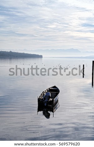 Germany, Bavaria, late afternoon at the lake called Ammersee with a small boat