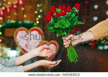 guy present girl flowers on Valentine's Day Royalty-Free Stock Photo #569583013