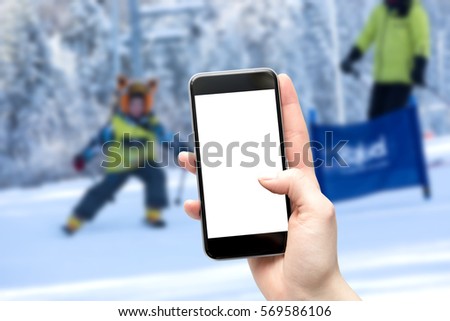 Mother takes a picture of your child in the classroom in kindergarten ski. Blank screen cut from place to copy. Background with shallow depth of field.