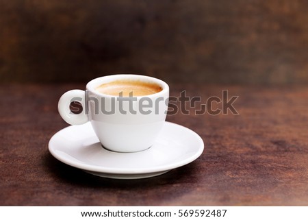 White cup of espresso coffee on background
 Royalty-Free Stock Photo #569592487