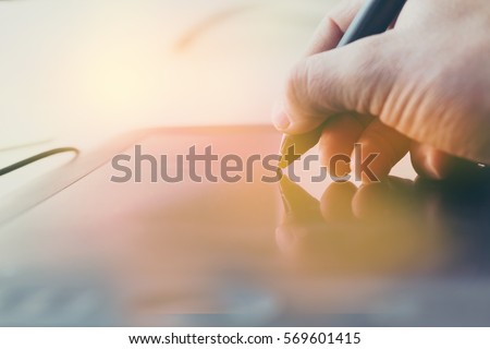 Concept of a digital signature on a tablet in the modern world. Royalty-Free Stock Photo #569601415