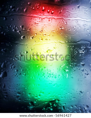 Background. Drops of a rain in the light of a traffic light.